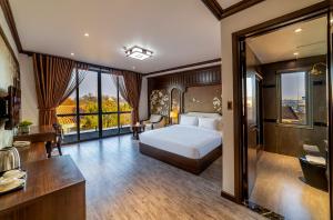 a hotel room with a bed and a bathroom at Le House DaLat in Da Lat