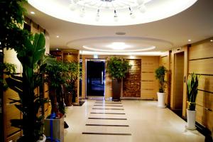 a hallway with potted plants and a ceiling at Princess Hotel in Seoul