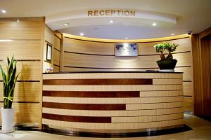 a hotel lobby with a reception desk and a sign at Princess Hotel in Seoul