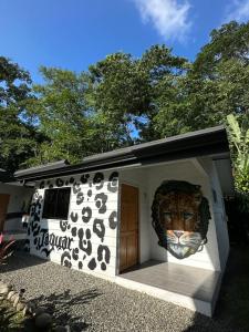 a building with a lion head on the side of it at Bungalows Sloth in Manzanillo