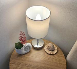 a lamp on a table with a candle and some shells at Dolphin Heads - Resort Unit - Absolute Beachfront! - Whitsunday Getaway! in Mackay