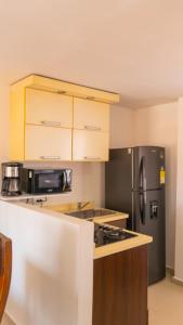 a kitchen with a black refrigerator and a microwave at Apt Bedroom Apartment era With Doorman in Bucaramanga