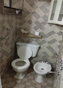 a bathroom with a toilet and a sink at Plaza Libertad in Santiago del Estero