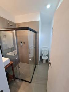 a bathroom with a shower and a toilet and a sink at Urban Justo Sierra in Guadalajara