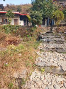 a stone path in front of a house at HIMALAYAN AAMA APARTMENT in Pokhara