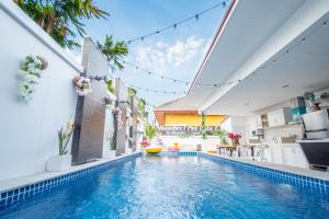a swimming pool in the middle of a building at November T Pool Villa 1, 4Beds Thai- Bali Jomtien Beach in Jomtien Beach