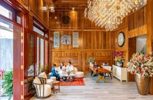 two people sitting at a table in a lobby at Mixay Boutique Hotel Da Nang in Danang +57 photos