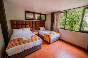 Postel nebo postele na pokoji v ubytování NaturaLodge Machu Picchu