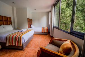 Postel nebo postele na pokoji v ubytování NaturaLodge Machu Picchu