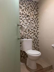 a bathroom with a toilet and a sink at Luna Guest House in Tanjungkarang-Telukbetung