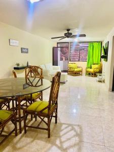 a living room with a table and chairs and a couch at Edificio Maratea Apt 704 El Rodadero in Santa Marta