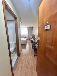 a hotel room with a desk and a room at 705. Flat hotel Go Inn in Brasilia