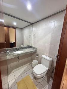 a bathroom with a toilet and a sink and a mirror at 705. Flat hotel Go Inn in Brasília