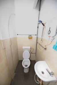 a bathroom with a toilet and a sink at OYO 89925 Innap Kota Bharu in Kota Bharu