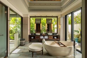 a bathroom with a tub and a sink at Jumeirah Bali in Uluwatu