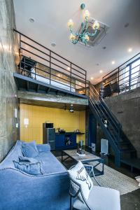 a living room with a blue bed and a staircase at SS Resort in Gapyeong