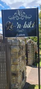 a sign for a house with a brick wall at Le-n-Biki Air B&B in Harrismith