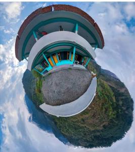 a building on top of a small island in the sky at Aman Resort, Tosh Village, Himachal Pradesh in Tosh