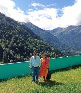a man and a woman standing on top of a mountain at Aman Resort, Tosh Village, Himachal Pradesh in Tosh