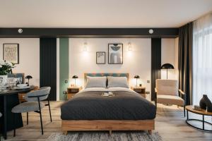 a bedroom with a bed and two chairs and a desk at ORSO Rooms & Apartments LoftAffair Collection in Warsaw