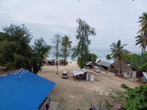 a view of a village with houses and the ocean at Jodari Hotel Nungwi in Nungwi