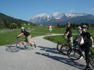 a group of people riding bikes on a road at Good Vintage Apartment in Bad Mitterndorf