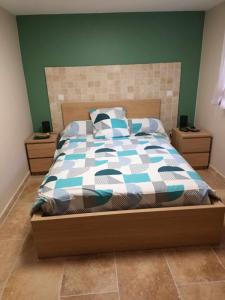 1 cama con edredón azul y blanco en un dormitorio en Résidence Gavarnie appart RDC, en Gèdre