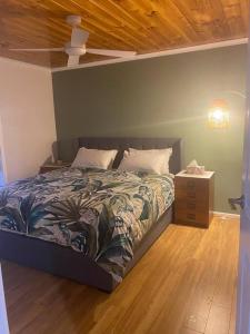a bedroom with a bed and a night stand at Coastal Retreat, 400 Metres to beach in Cowes