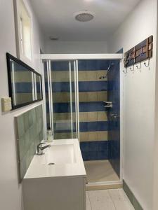 a bathroom with a sink and a shower at Coastal Retreat, 400 Metres to beach in Cowes