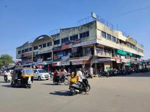 a group of people riding motorcycles on a city street at FabHotel Lake View I in Dabhoi