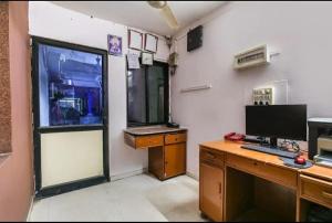 an office with a desk with a computer and a window at FabHotel Lake View I in Dabhoi