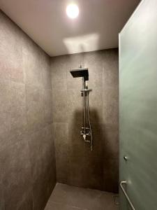 a bathroom with a shower with a shower head at Bluewater Maribago Beach Resort in Mactan