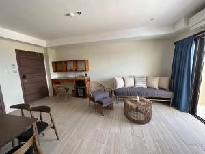 a living room with a couch and a table and chairs at Bluewater Maribago Beach Resort in Mactan