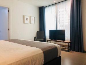 a hotel room with a bed and a television at Urban Gran Plaza in Guadalajara