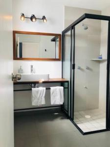a bathroom with a shower and a sink and a mirror at Urban Gran Plaza in Guadalajara