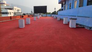 a row of white barriers on a red floor at Hotel moon light in Rājgīr