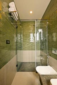 bagno con doccia in vetro e lavandino di The Banyan Tree Villa A4 by Stay ALYF, Siolim a Siolim