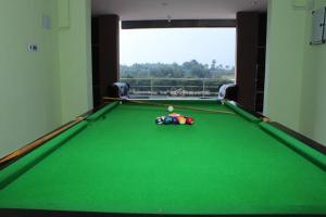 a pool table with a ball on top of it at Alegria Resort and SPA, Kovalam in Tirupporūr