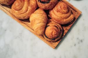 a pile of pastries on a wooden plate at Morabito Art Villa in Canggu +26 photos