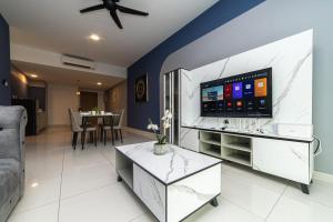 a living room with a tv and a couch at Mosaic Southkey Marine Blue 2BR by Our Stay in Johor Bahru