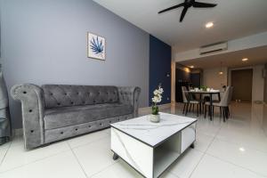 a living room with a couch and a table at Mosaic Southkey Marine Blue 2BR by Our Stay in Johor Bahru