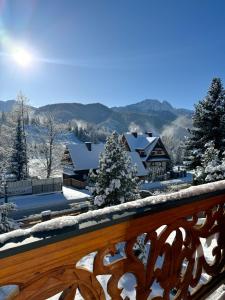 a view of a snow covered town with houses at Villa 11 Folk & Design in Zakopane
