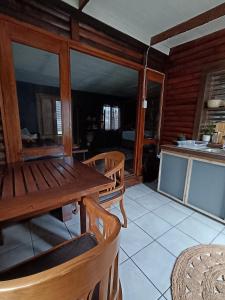 a dining room with a wooden table and chairs at Fire Fly Cabin in Knysna