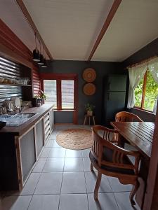 a kitchen with a counter and a table and chairs at Fire Fly Cabin in Knysna