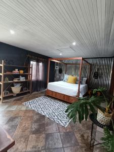 a bedroom with a bed with a wooden headboard at Fire Fly Cabin in Knysna