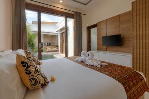 a bedroom with a bed with two stuffed animals on it at Lodji Ubud in Ubud +42 photos