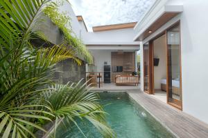 an indoor pool in a villa with a bedroom at Lodji Ubud in Ubud
