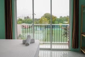 een kamer met een bed en een groot raam bij Green Vista Maafushi in Maafushi