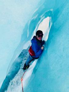 una persona sugli sci in una grotta di ghiaccio di Six Kamahi Guest House & Studio Unit a Franz Josef
