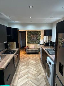 a kitchen with a sink and a living room at Ivy Villa in Trench